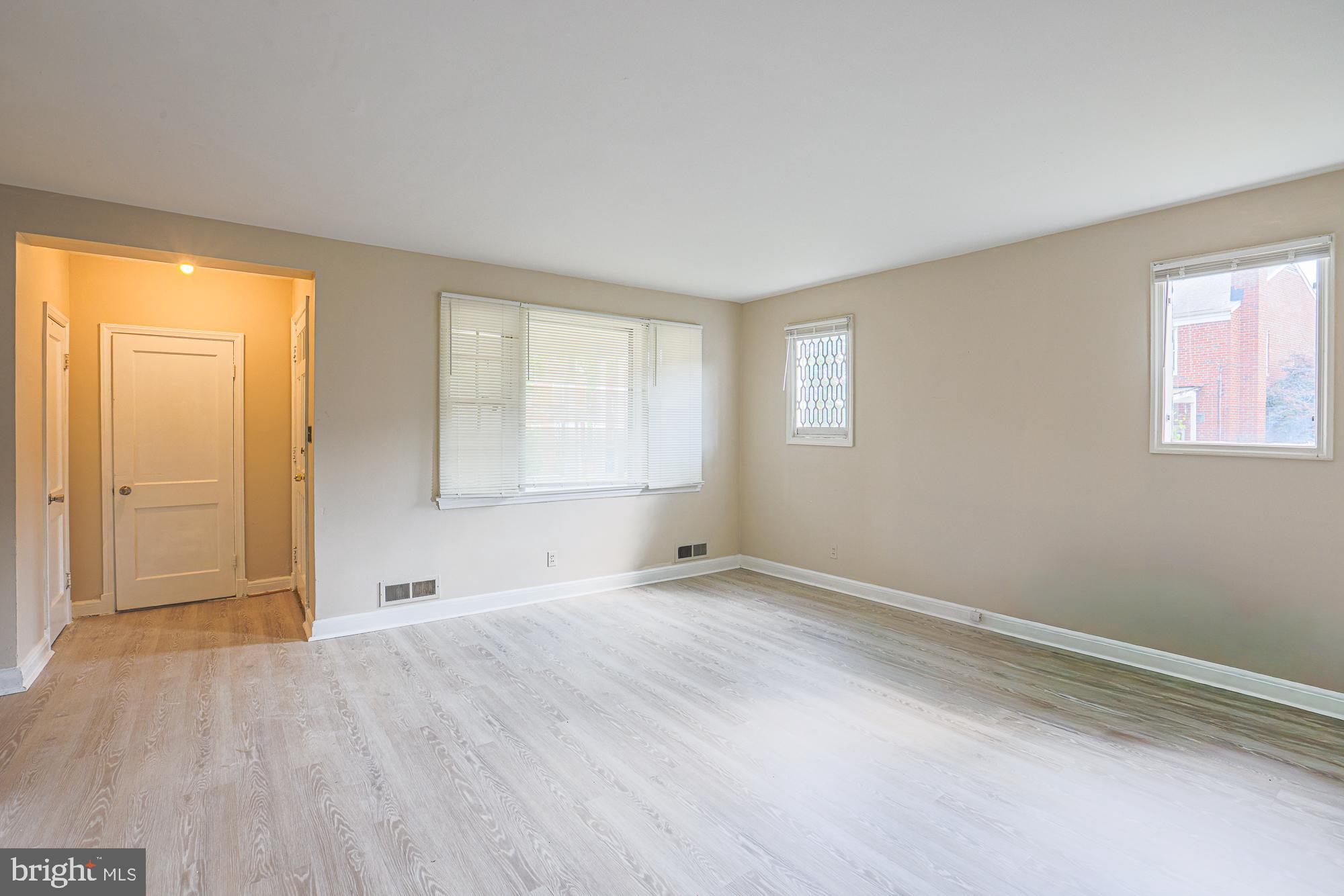 3914 Bancroft Road Baltimore, MD 21215 - Photo 7 of 25 a view of an empty room with wooden floor and a window