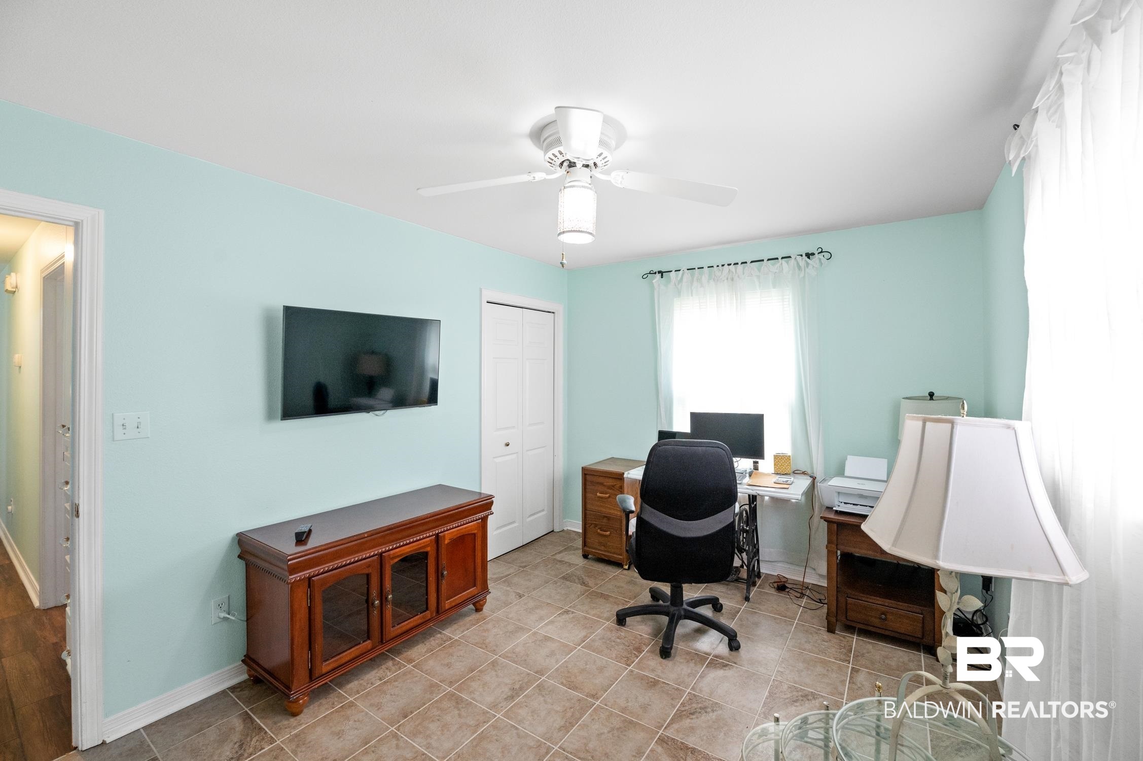 2553 Santa Rosa Drive Lillian, AL 36549 - Photo 34 of 51 Home office with light tile patterned flooring, a ceiling fan, and baseboards