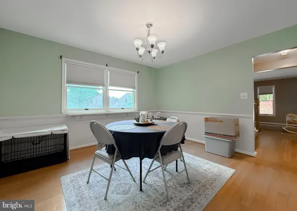 a kitchen with stainless steel appliances kitchen island a large window in it