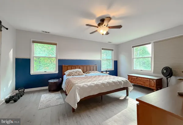 a bedroom with a bed and a shower