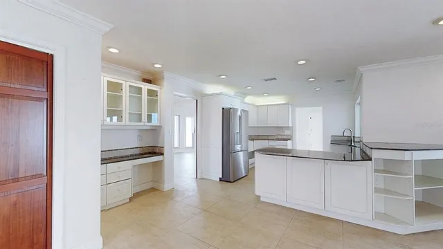 a spacious bathroom with a granite countertop sink and a mirror