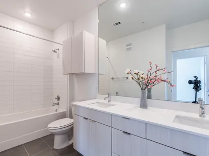 a kitchen with stainless steel appliances granite countertop a stove a refrigerator and a microwave