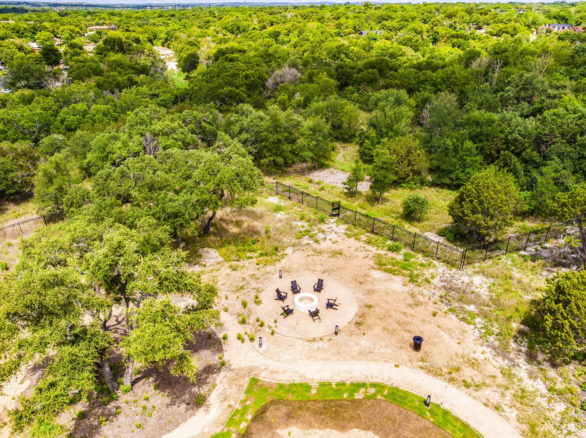 4802 South Congress Avenue, Unit 310 Austin, TX 78745 - Photo 29 of 37 Aerial view of the fire pit with greenbelt behind.