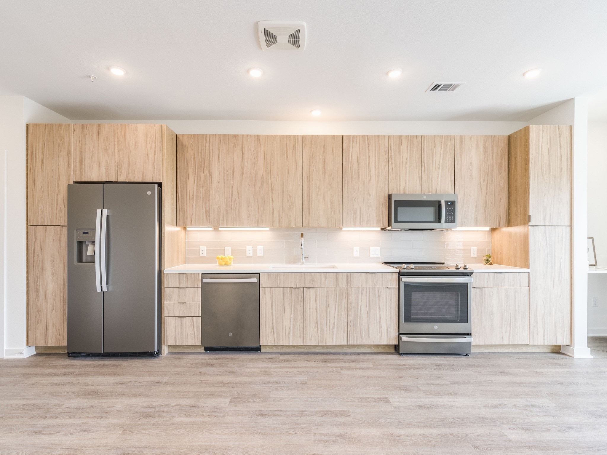4802 South Congress Avenue, Unit 310 Austin, TX 78745 - Photo 3 of 37 Light and bright kitchen with soft close cabinets, stainless steel appliances and recessed lighting.