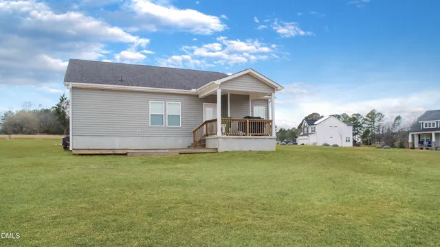 a front view of a house with a garden and yard