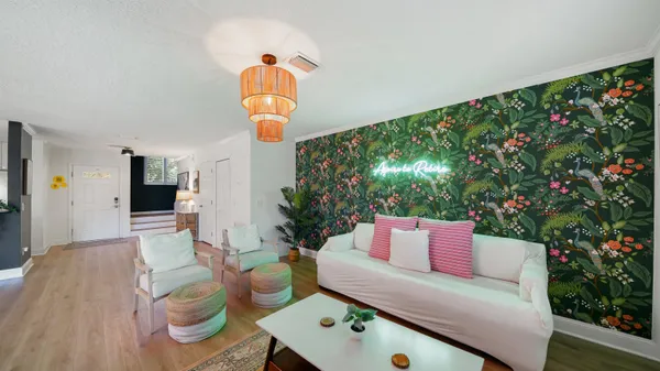 a living room with furniture and a potted plant