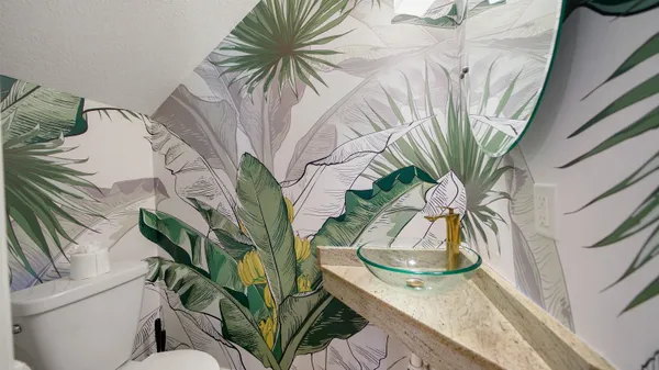 a vase of flowers sitting on a table with chairs