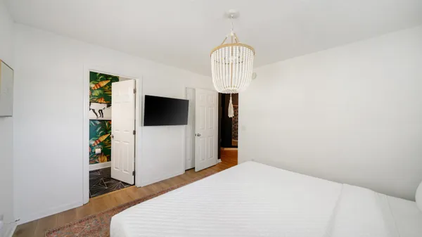 a bedroom with a bed and a flat screen tv