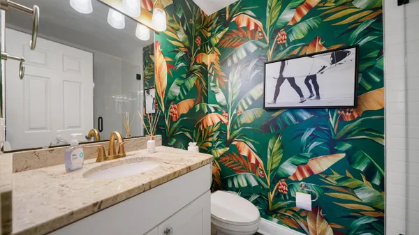 a bathroom with a granite countertop sink and a mirror