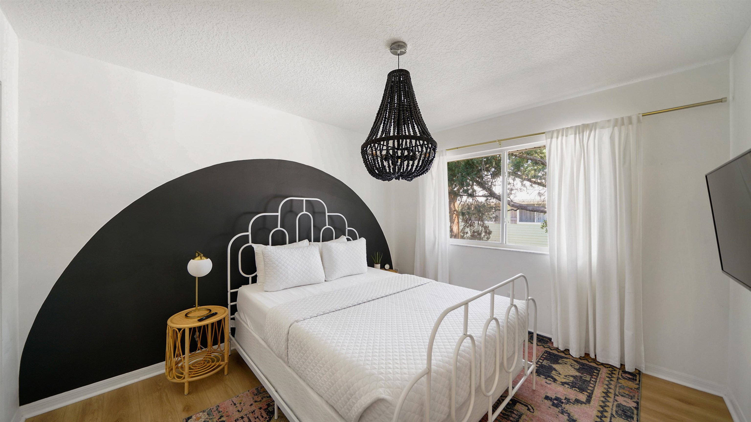 108 A Street, Unit A St. Augustine, FL 32080 - Photo 20 of 38 a bedroom with a bed and wooden floor