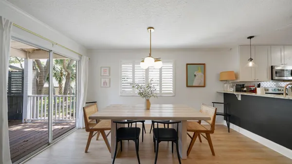 a dining room with furniture window and wooden floor
