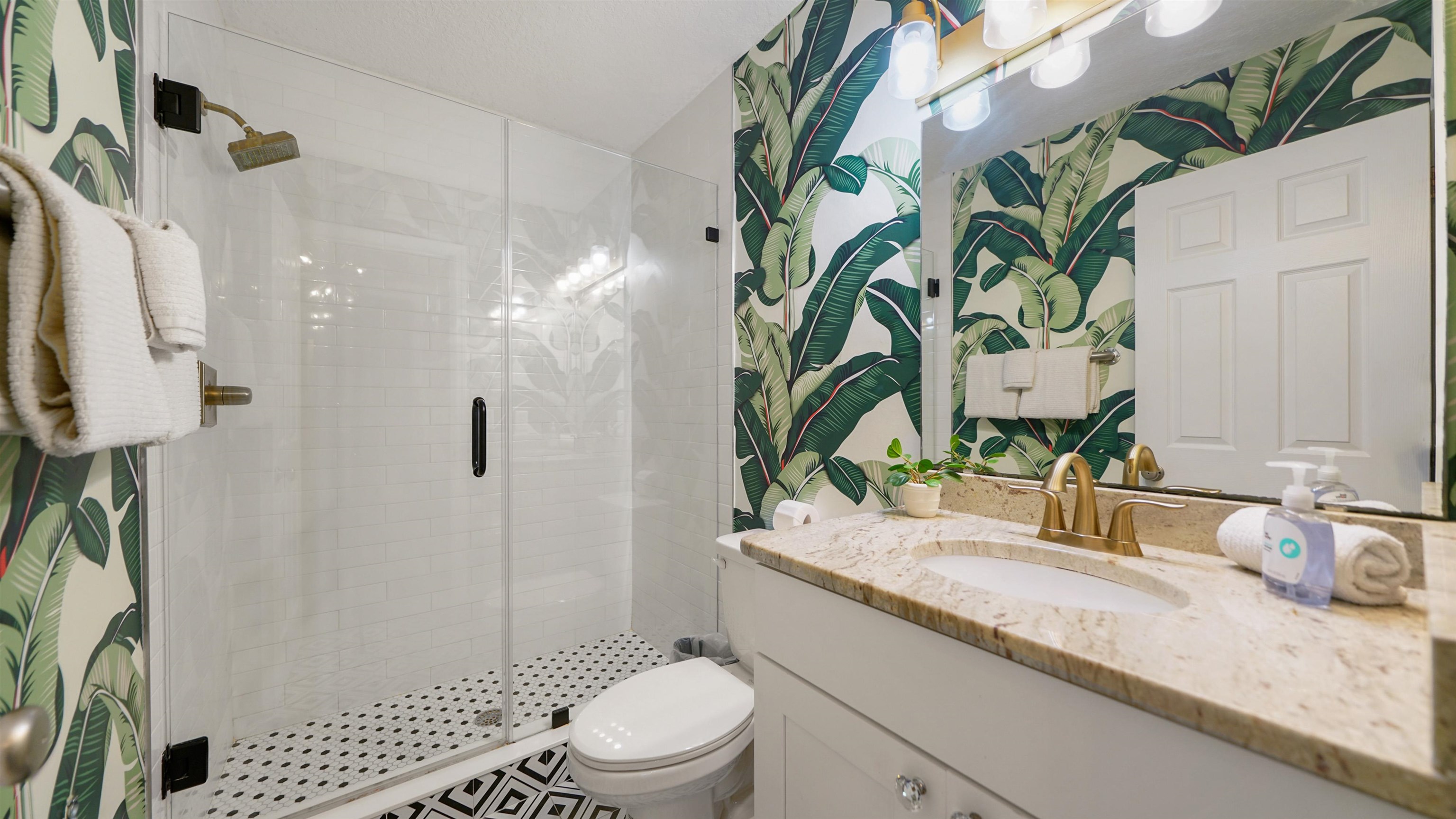 108 A Street, Unit A St. Augustine, FL 32080 - Photo 22 of 38 a bathroom with a granite countertop sink a toilet and shower