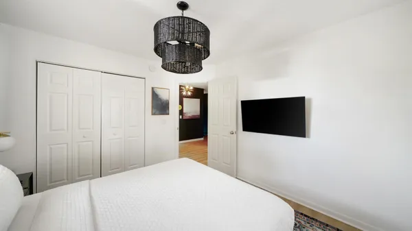 a bedroom with a bed and a television