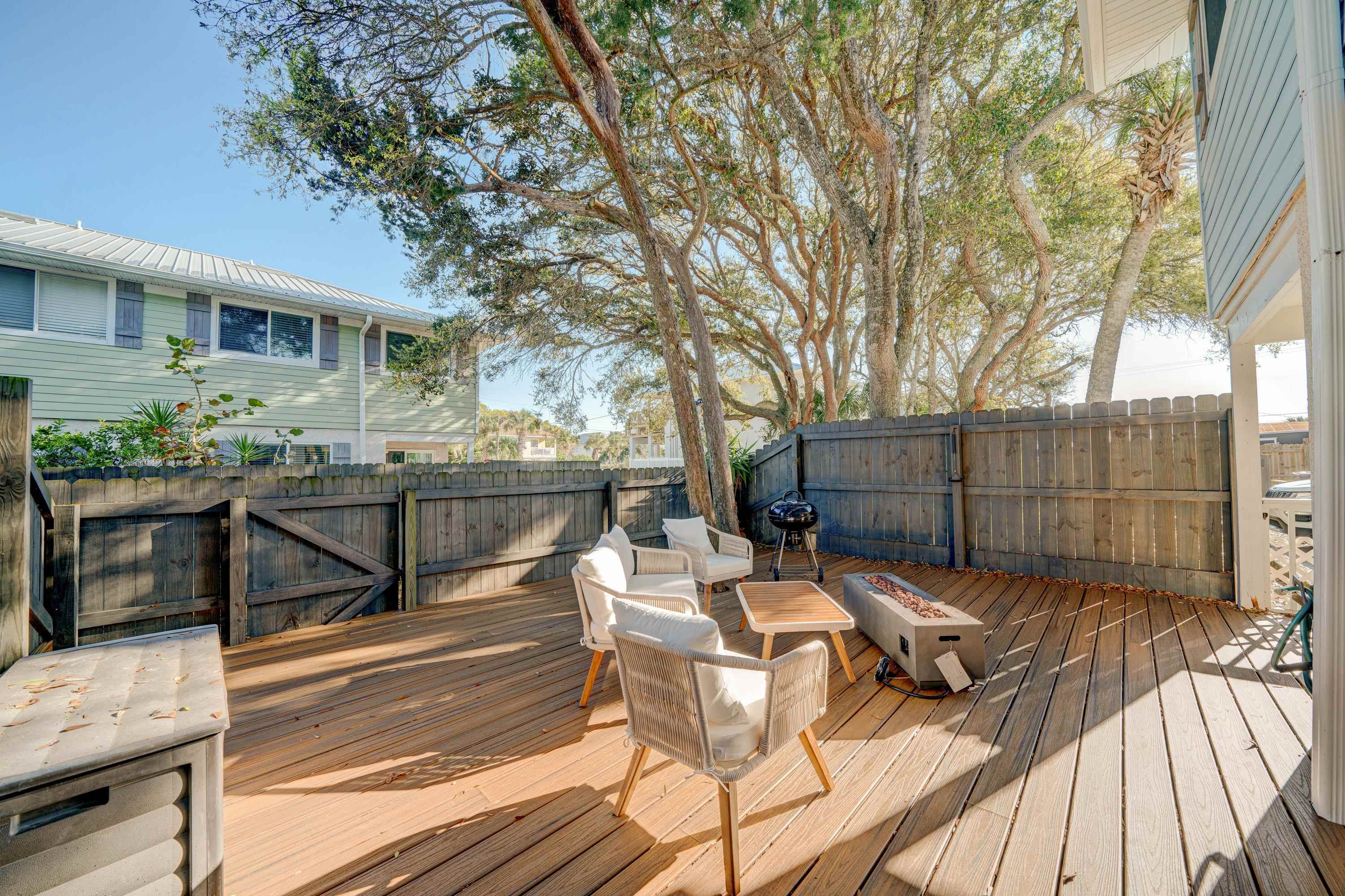 108 A Street, Unit A St. Augustine, FL 32080 - Photo 28 of 38 a view of a patio with table and chairs with wooden floor and fence
