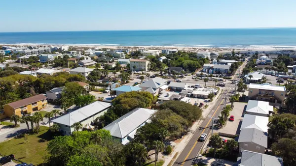 an aerial view of a city with ocean view
