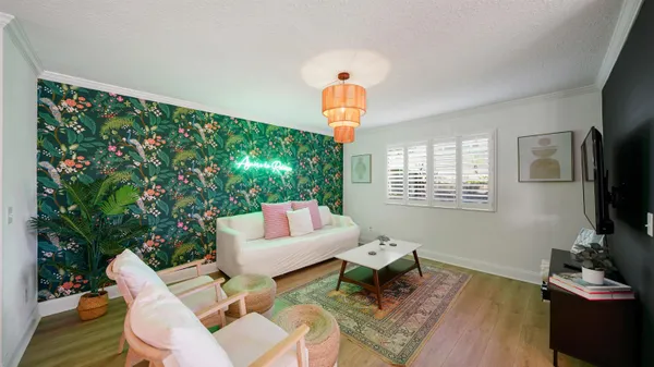 a living room with furniture a window and a flat screen tv