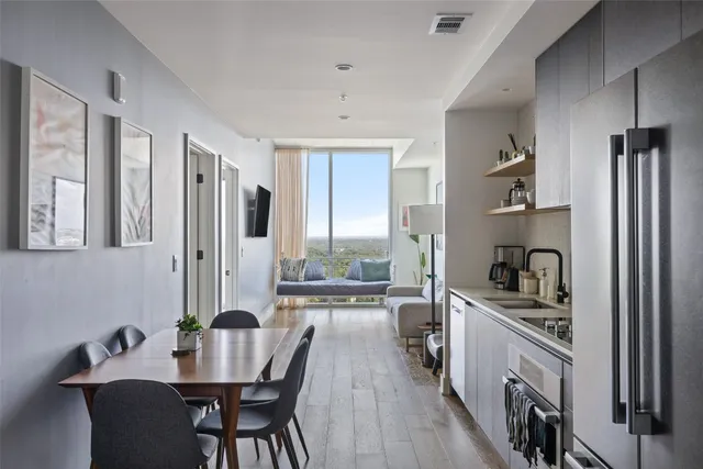 a kitchen with refrigerator cabinets and wooden floor