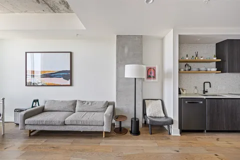 a living room with furniture and a lamp