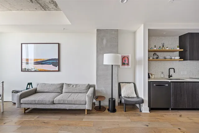 a living room with furniture and a lamp