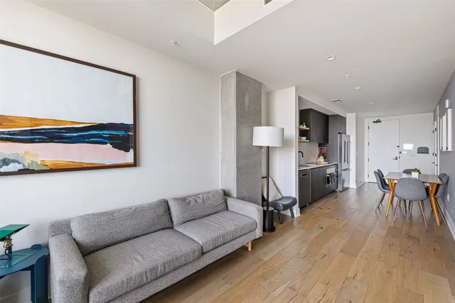 a living room with furniture and kitchen view