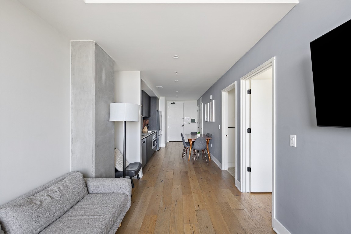 48 East Avenue, Unit 2405 Austin, TX 78701 - Photo 14 of 40 a living room with furniture and a flat screen tv