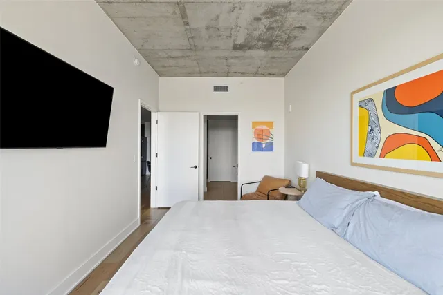 a bedroom with a bed and flat screen tv