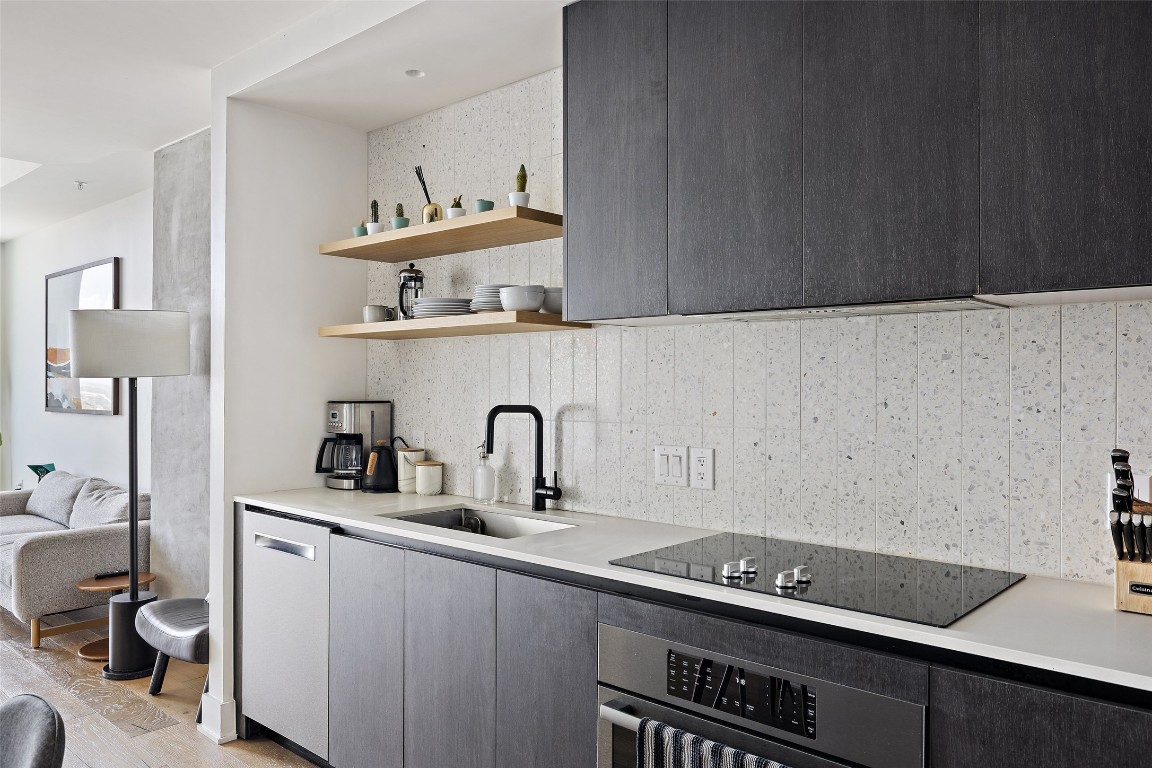 48 East Avenue, Unit 2405 Austin, TX 78701 - Photo 2 of 40 a kitchen with a sink and cabinets