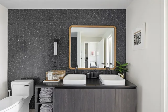 a bathroom with a granite countertop sink and a mirror