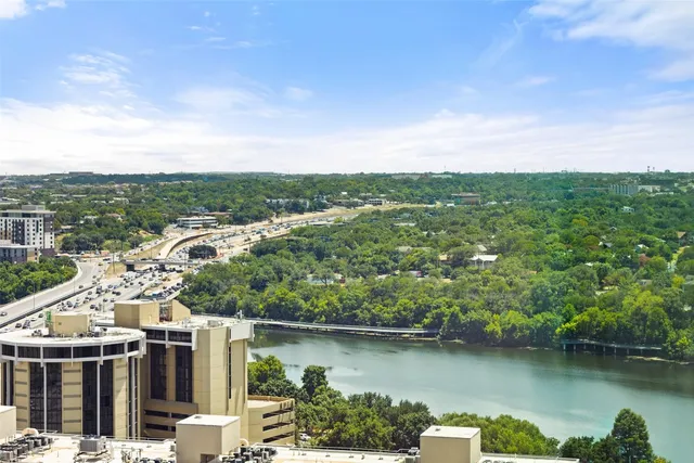 an aerial view of a house with a garden and lake view