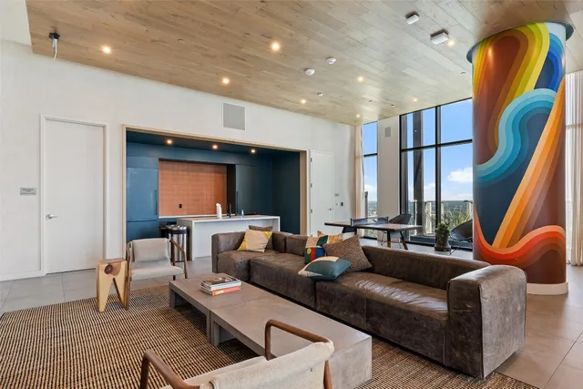 a living room with furniture and a potted plant