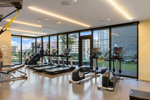 a room with gym equipment and floor to ceiling window