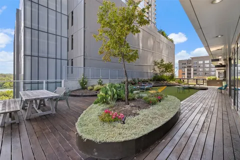 a swimming pool with outdoor seating and wooden floor