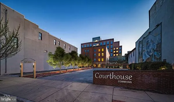 a kitchen with stainless steel appliances granite countertop a stove a refrigerator a sink a microwave and wooden cabinets