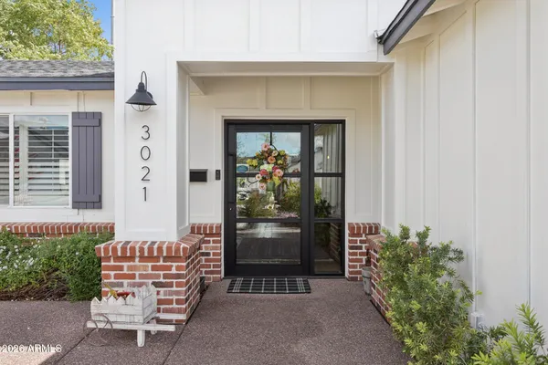 a front view of a house with outdoor seating