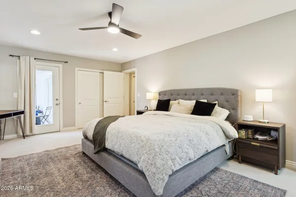 a bedroom with a bed and a chandelier