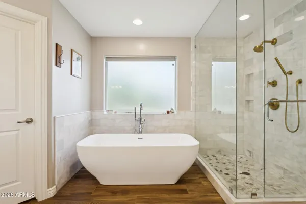 a bathroom with a bathtub and shower