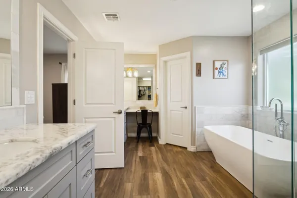 a spacious bathroom with a granite countertop tub sink and a mirror