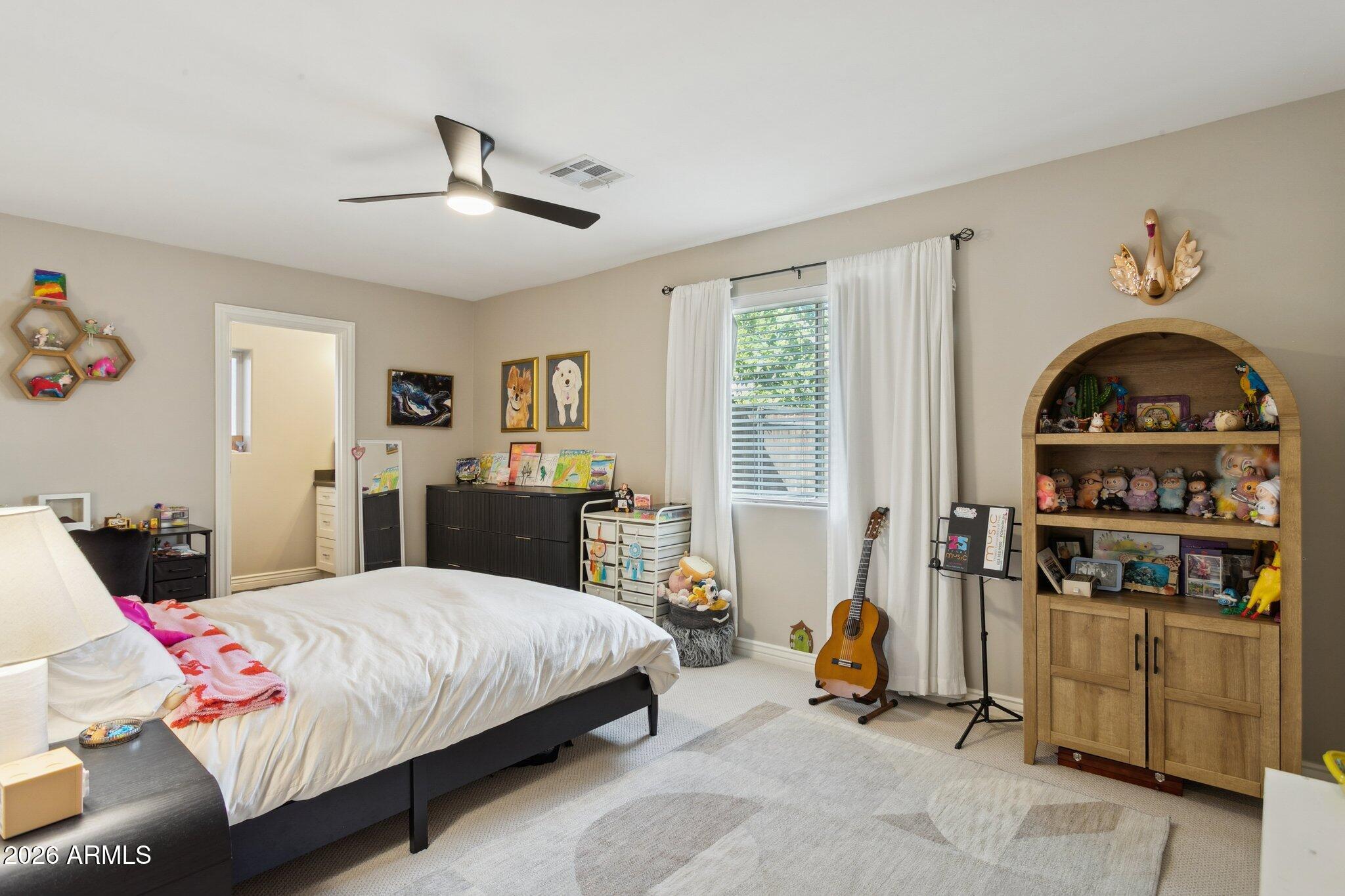 3021 North 47th Place Phoenix, AZ 85018 - Photo 17 of 33 a bedroom with a bed a books bucket with desk and chair