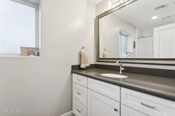 a bathroom with a sink and a mirror