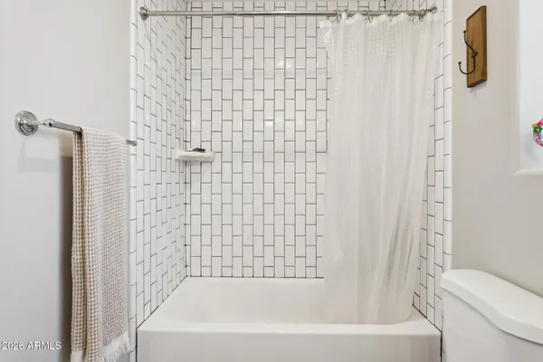 a bathroom with a bathtub and shower