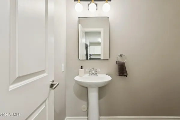 a bathroom with a sink a mirror and a vanity