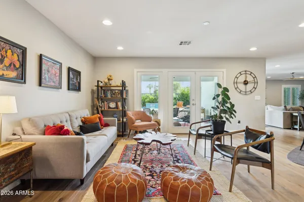 a living room with furniture and wooden floor