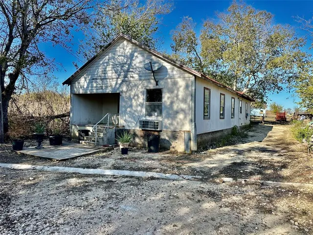 a view of a house with yard and sitting area