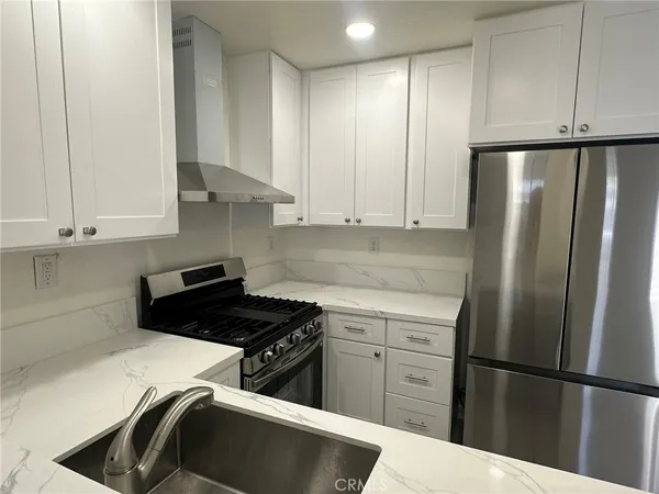 a kitchen with appliances cabinets and a counter top space