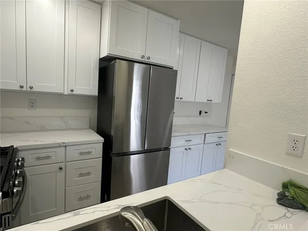 a kitchen with a refrigerator and a stove