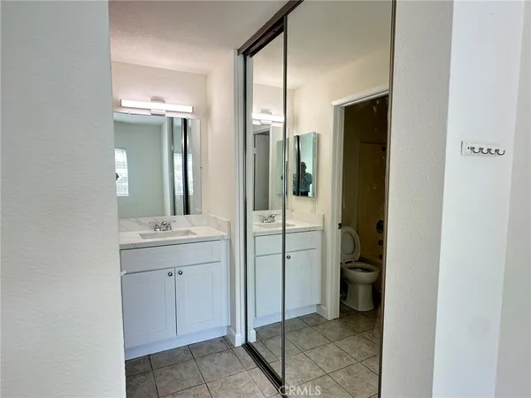 a bathroom with a granite countertop sink mirror and shower