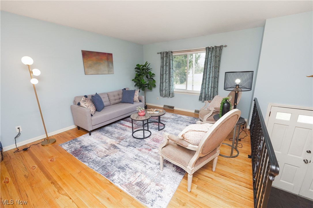 2674 Smith Road Fairlawn, OH 44333 - Photo 9 of 31 Living area featuring baseboards, visible vents, and wood finished floors