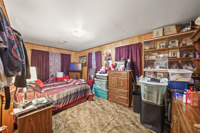 a bedroom with furniture and a window