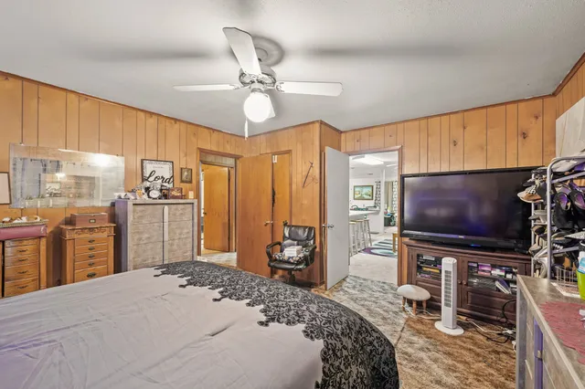a bedroom with a bed and a flat screen tv