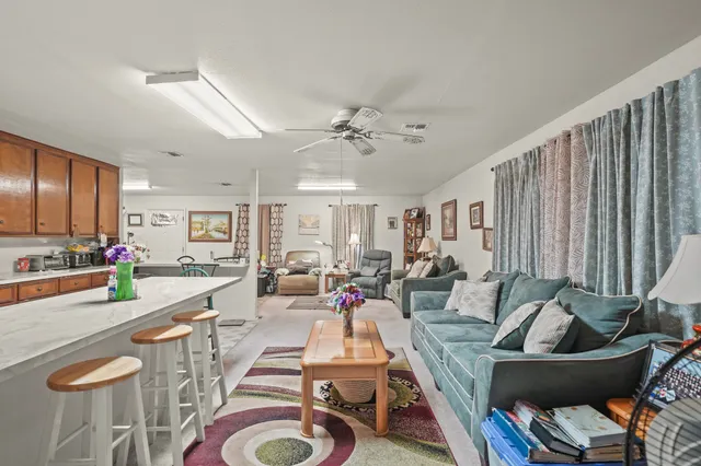 a very nice looking living room with a couch and a chandelier